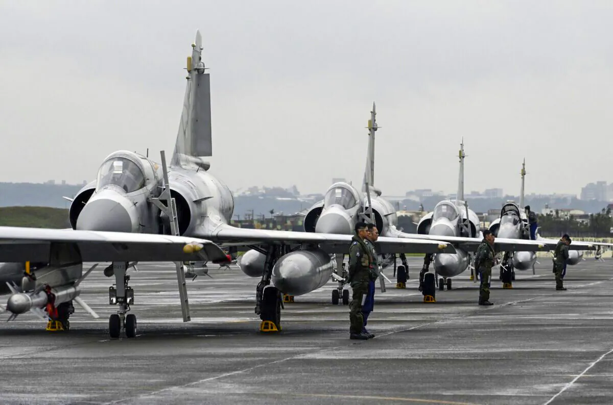 Taiwan air force pilots stand next to French-made Mirage fighter jets during an annual exercise at the Hsinchu air force base on Jan. 16, 2019. (Sam Yeh / AFP via Getty Images)