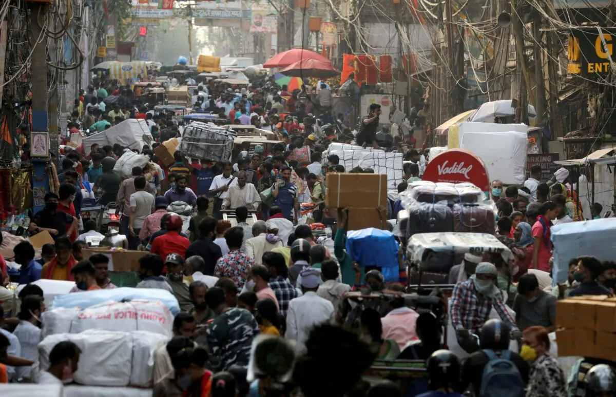 People walk at a crowded market in the old quarters of Delhi, India, on April 6, 2021. (Anushree Fadnavis/Reuters)