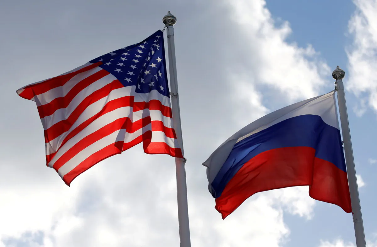 Russian and U.S. state flags fly near a factory in Vsevolozhsk, Leningrad Region, Russia, on March 27, 2019. (Anton Vaganov/Reuters)