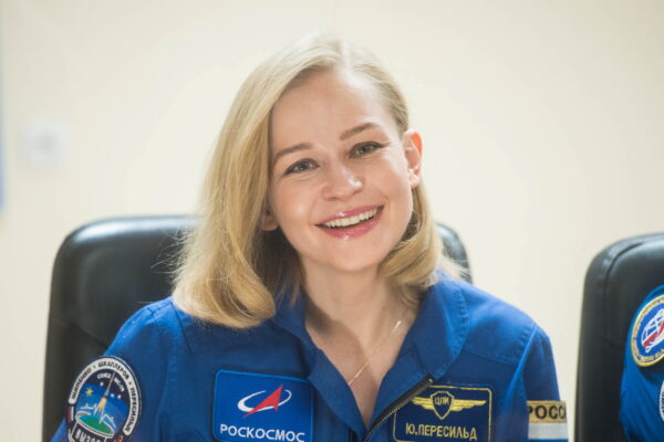 Crew members attend a news conference ahead of the expedition to the International Space Station at the Baikonur Cosmodrome