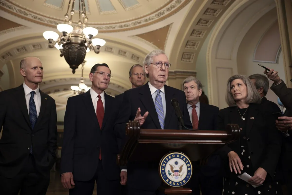 Senate Minority Leader Mitch McConnell (R-Ky.) addresses reporters following a weekly Republican policy luncheon as (L-R) Sen. Rick Scott (R-Fla.), Sen. John Barrasso (R-Wyo.), Sen. John Thune (R-S.D.), Sen. Roy Blunt (R-Mo.), and Sen. Joni Ernst (R-Iowa) look on in Washington, on Oct. 5, 2021. (Anna Moneymaker/Getty Images)