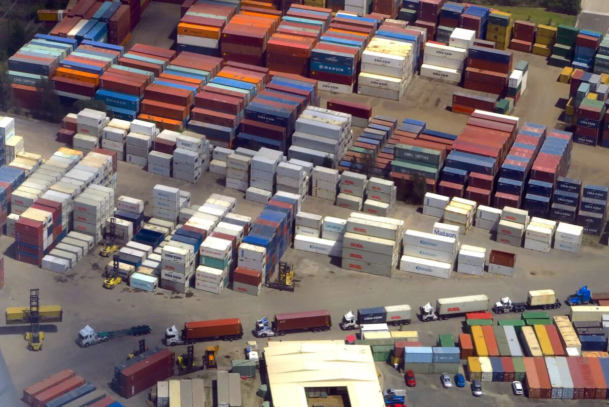A forklift unloads shipping containers from trucks at a storage facility located near Sydney Airport in Australia on Nov. 30, 2017. (David Gray/Reuters)