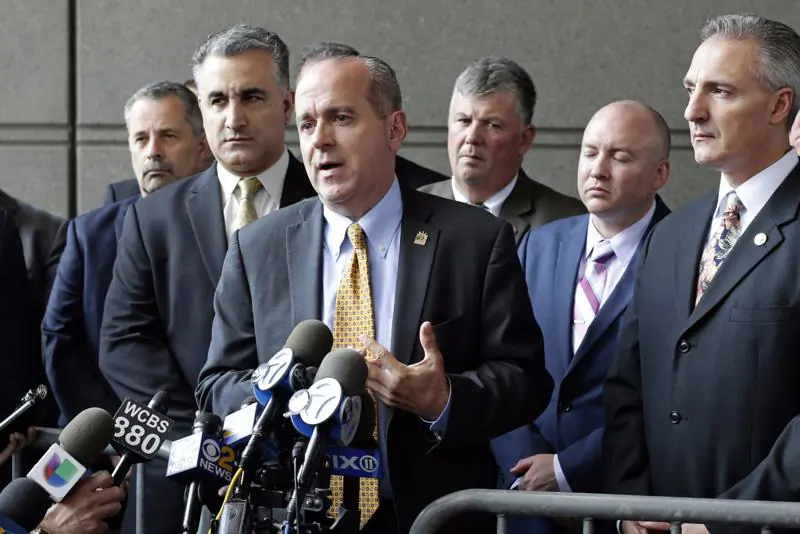 In this May 31, 2017, file photo, Sgt. Ed Mullins, the head of the Sergeants Benevolent Association, center, speaks to the media outside of the Bronx Supreme Court in the Bronx borough of New York. (Frank Franklin II/AP Photo)