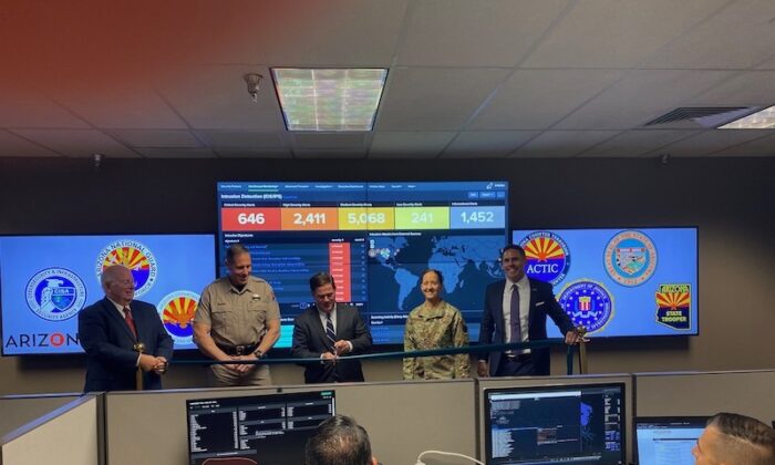 Arizona Gov. Doug Ducey (center) is joined by Tim Roemer, Director of the Arizona Department of Homeland Security and Chief Information Security Officer, at an unveiling of the new Cyber Command Center in Phoenix on Oct. 4, 2021. Also pictured are Colonel Heston Silbert, Director of the Department of Public Safety; Andy Tobin, Director of the Department of Administration; and Adjutant General Kerry Muehlenbeck, Director of the Department of Emergency and Military Affairs. (Office of the Governor Doug Ducey)
