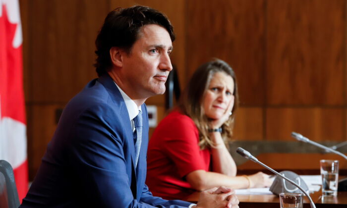Deputy Prime Minister and Minister of Finance Chrystia Freeland and Prime Minister Justin Trudeau listen to a question at a news conference in Ottawa on Oct. 6, 2021. (Patrick Doyle/Reuters)
