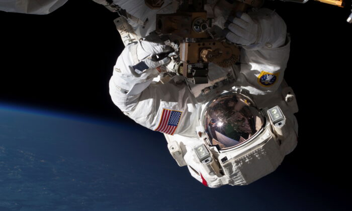 NASA Expedition 35 Flight Engineers Chris Cassidy (pictured) and Tom Marshburn (out of frame) conduct a spacewalk to inspect and replace a pump controller box on the International Space Station's far port truss (P6) leaking ammonia coolant, on May 11, 2013. (NASA/Handout via Reuters)