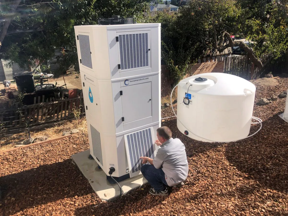 Ted Bowman, design engineer with Tsunami Products, installs a unit in homeowner Don Johnson's backyard in Benicia, Calif., on Sept. 28, 2021. (Haven Daily/AP Photo)