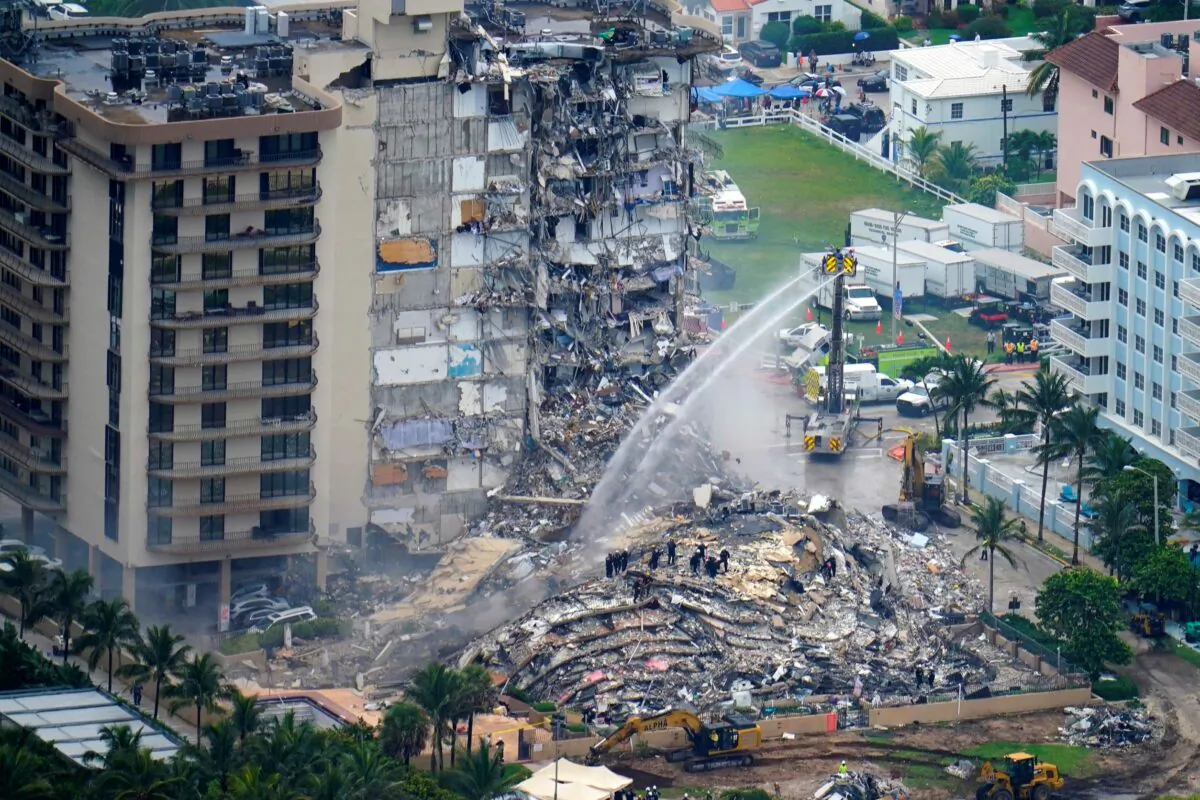 In this file photo, rescue personnel work at the remains of the Champlain Towers South condo building in Surfside, Fla., on June 25, 2021. (Gerald Herbert/AP Photo)