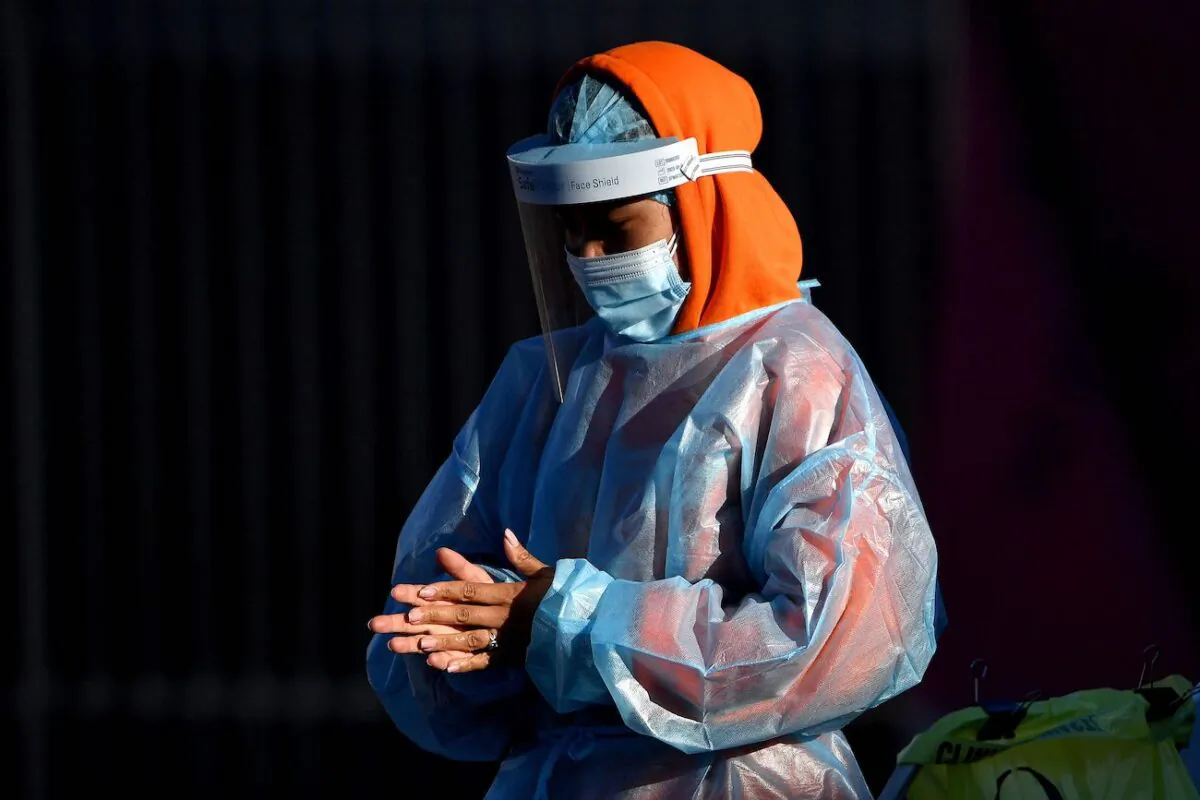 A health worker preparing to take swab samples from residents at a COVID-19 drive-through testing site in western Sydney on Aug. 4, 2021. (Saeed Khan/AFP via Getty Images)