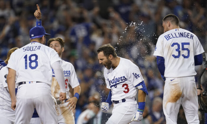  Los Angeles Dodgers celebrate with Chris Taylor (3) after he hit a home run during the ninth inning to win a National League Wild Card playoff baseball game 3-1 over the St. Louis Cardinals in Los Angeles on Oct. 6, 2021. (AP Photo/Marcio Jose Sanchez)