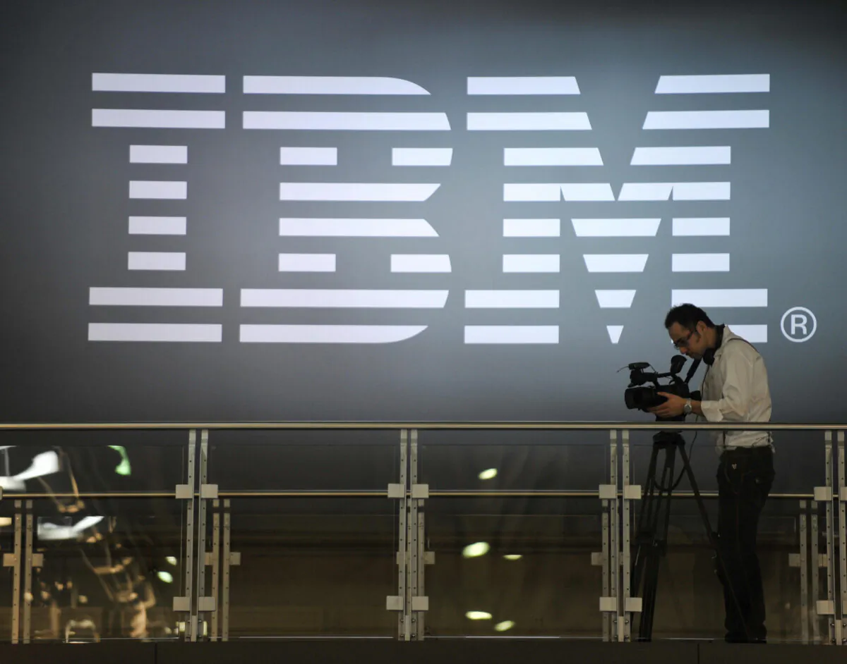 A cameramen shoots footage in front of an IBM logo at the world's biggest high-tech fair, the CeBIT, in Hanover, Germany, on March 5, 2009. (John MacDougall/AFP via Getty Images)