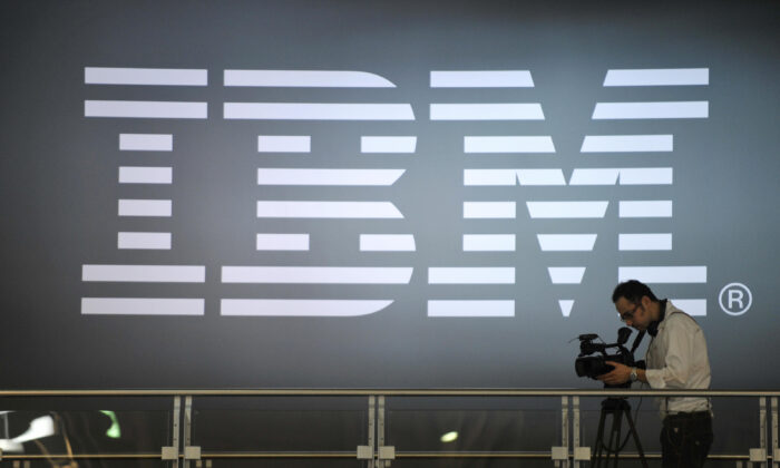 A cameramen shoots footage in front of an IBM logo at the world's biggest high-tech fair, the CeBIT, in Hanover, Germany, on March 5, 2009. (John MacDougall/AFP via Getty Images)