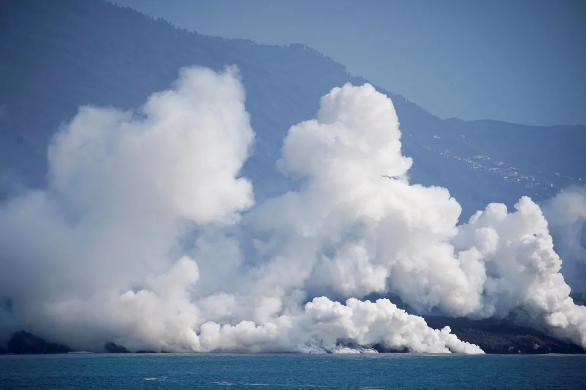 Smoke rises as lava flows into the sea following the eruption of a volcano in Canary Island of La Palma, Spain, on Oct. 6, 2021. (Juan Medina/Reuters)