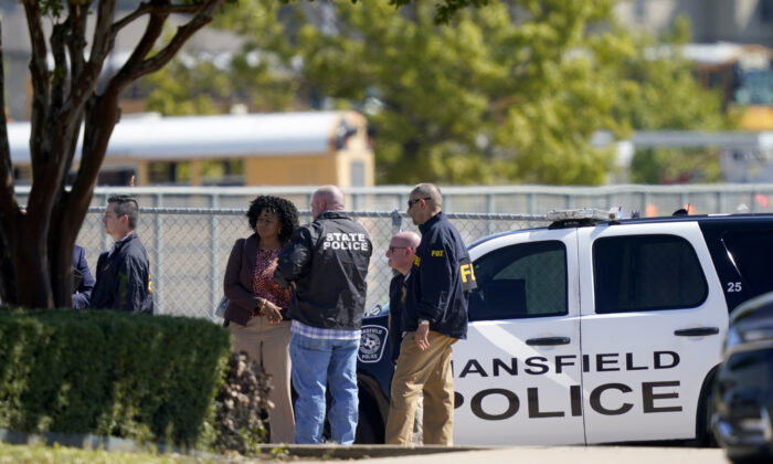 Law enforcement officers from different agencies gather in the parking lot of Timberview High School after a shooting inside the school located in south Arlington, Texas, on Oct. 6, 2021. (LM Otero/AP Photo)