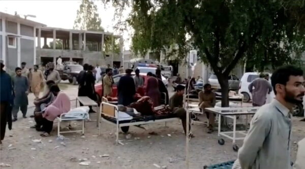 Social media video still of people gathering outside a hospital following an earthquake in Harnai, Pakistan