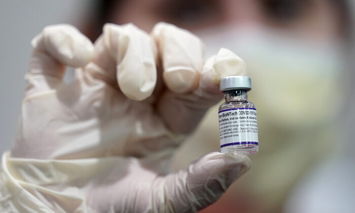 A healthcare worker holds a vial of the Pfizer COVID-19 vaccine at Jackson Memorial Hospital in Miami, Fla., on Oct. 5, 2021. (Lynne Sladky/AP Photo)