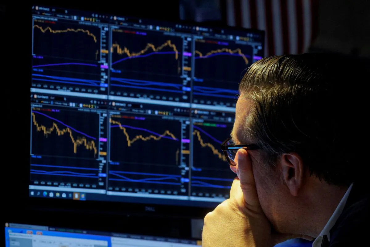 A specialist trader works inside a booth on the floor of the New York Stock Exchange (NYSE) in New York City on Oct. 6, 2021. (Brendan McDermid/Reuters)