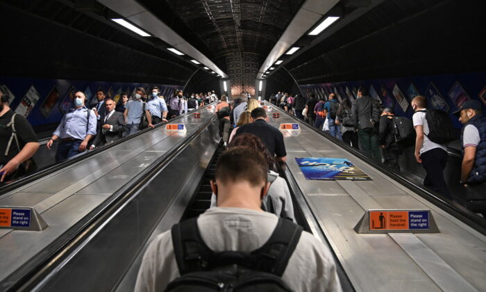 Workers travel through London Bridge rail and underground station during the morning rush hour in London on Sept. 8, 2021. (Toby Melville/Reuters)