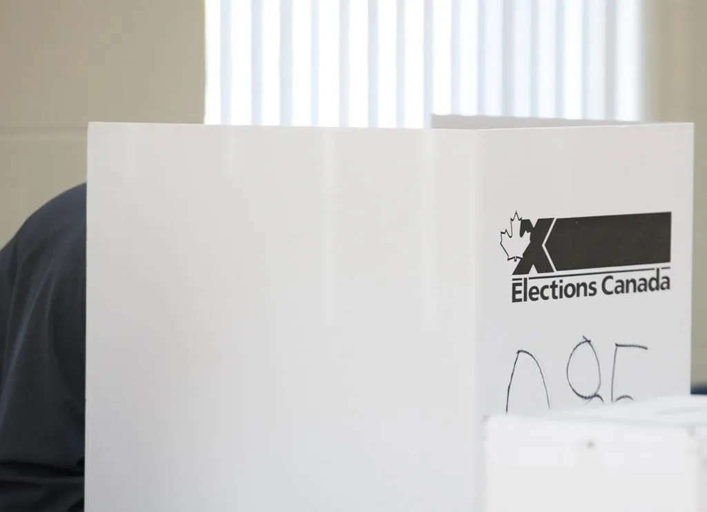 A man casts his ballot at a polling station on federal election day in Shawinigan, Que., on Oct. 21, 2019. (The Canadian Press/Graham Hughes)