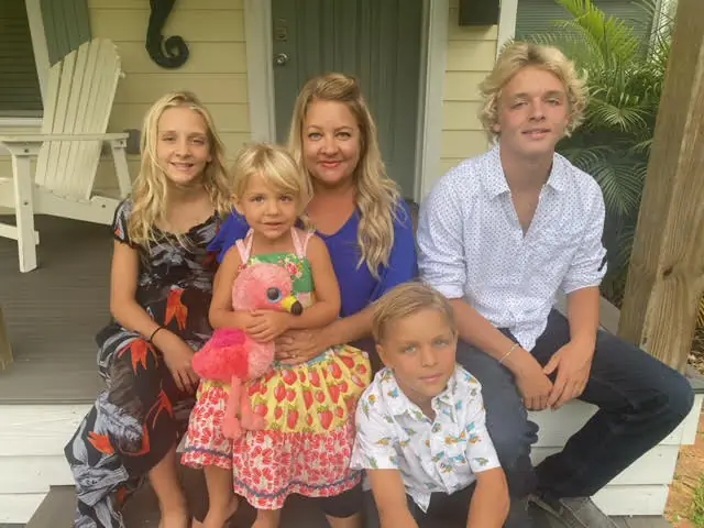 Rylin, Hartlyn, Casey Paxton and Nolan Goff gather on the front porch  of their home in Flagler Beach, Fla. October 7, 2021 (Photo, courtesy of Casey Goff) 