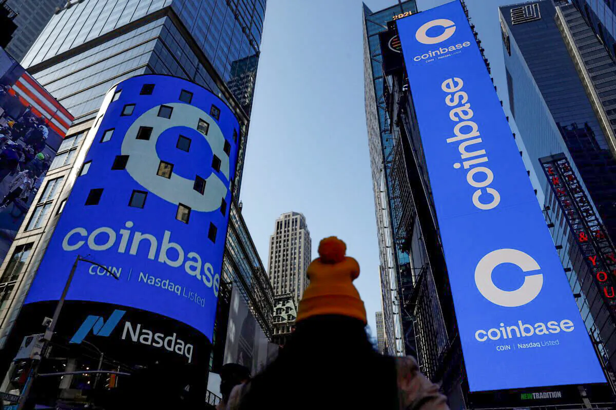 The logo for Coinbase Global Inc, the biggest U.S. cryptocurrency exchange, is displayed on the Nasdaq MarketSite jumbotron and others at Times Square in New York, on April 14, 2021. (Shannon Stapleton/Reuters)