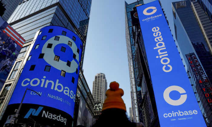 The logo for Coinbase Global Inc, the biggest U.S. cryptocurrency exchange, is displayed on the Nasdaq MarketSite jumbotron and others at Times Square in New York, on April 14, 2021. (Shannon Stapleton/Reuters)