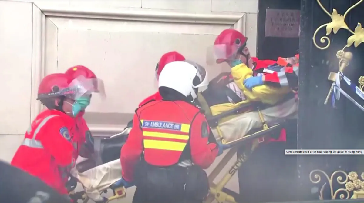 Emergency personnel carrying person in stretcher out from building in Hong Kong, on Oct. 8, 2012. (Screenshot via NTD/TVB via Reuters)