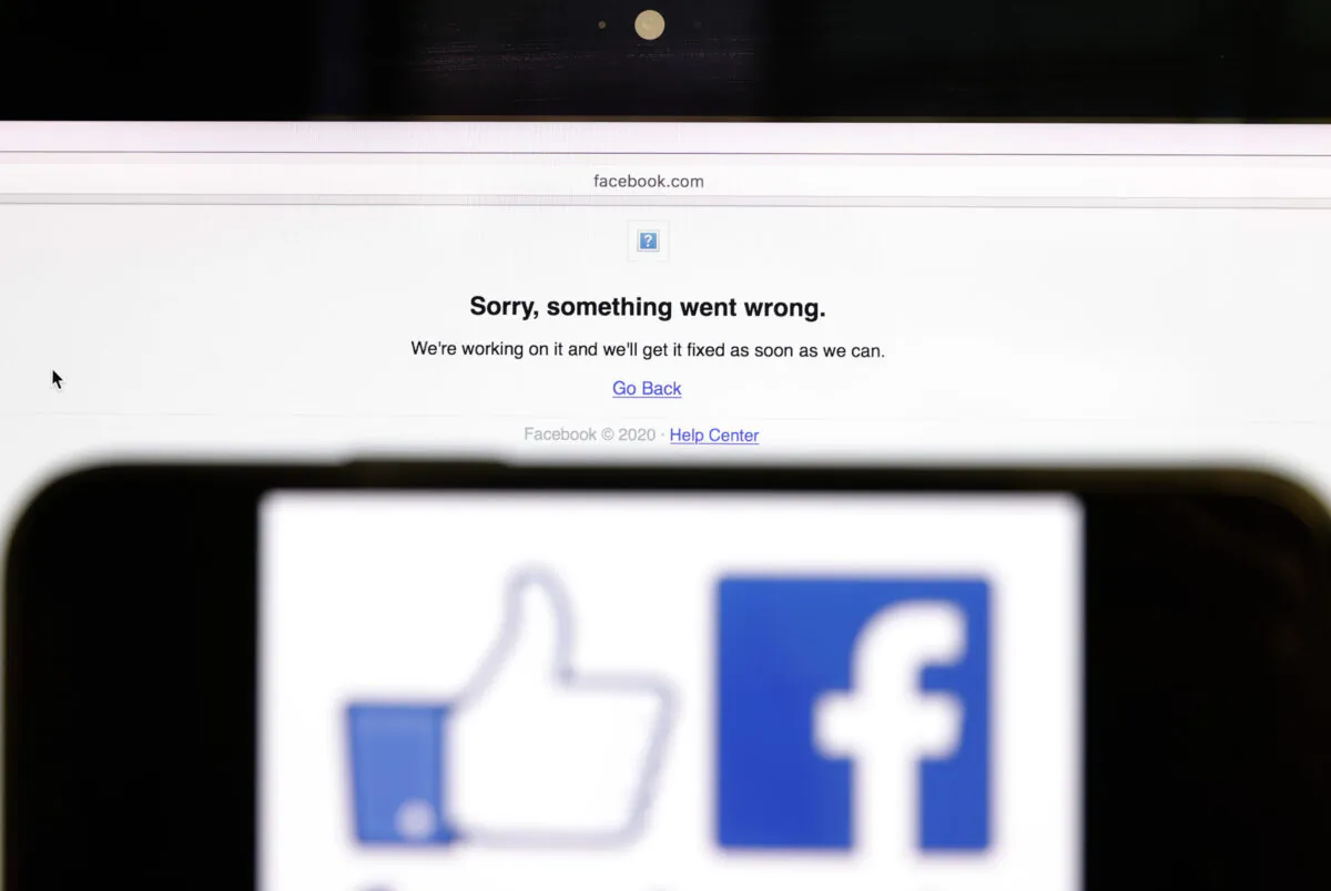 In this photo illustration, the Facebook logo is displayed next to a screen indicating a problem in San Anselmo, Calif., on Oct. 4, 2021. (Justin Sullivan/Getty Images)