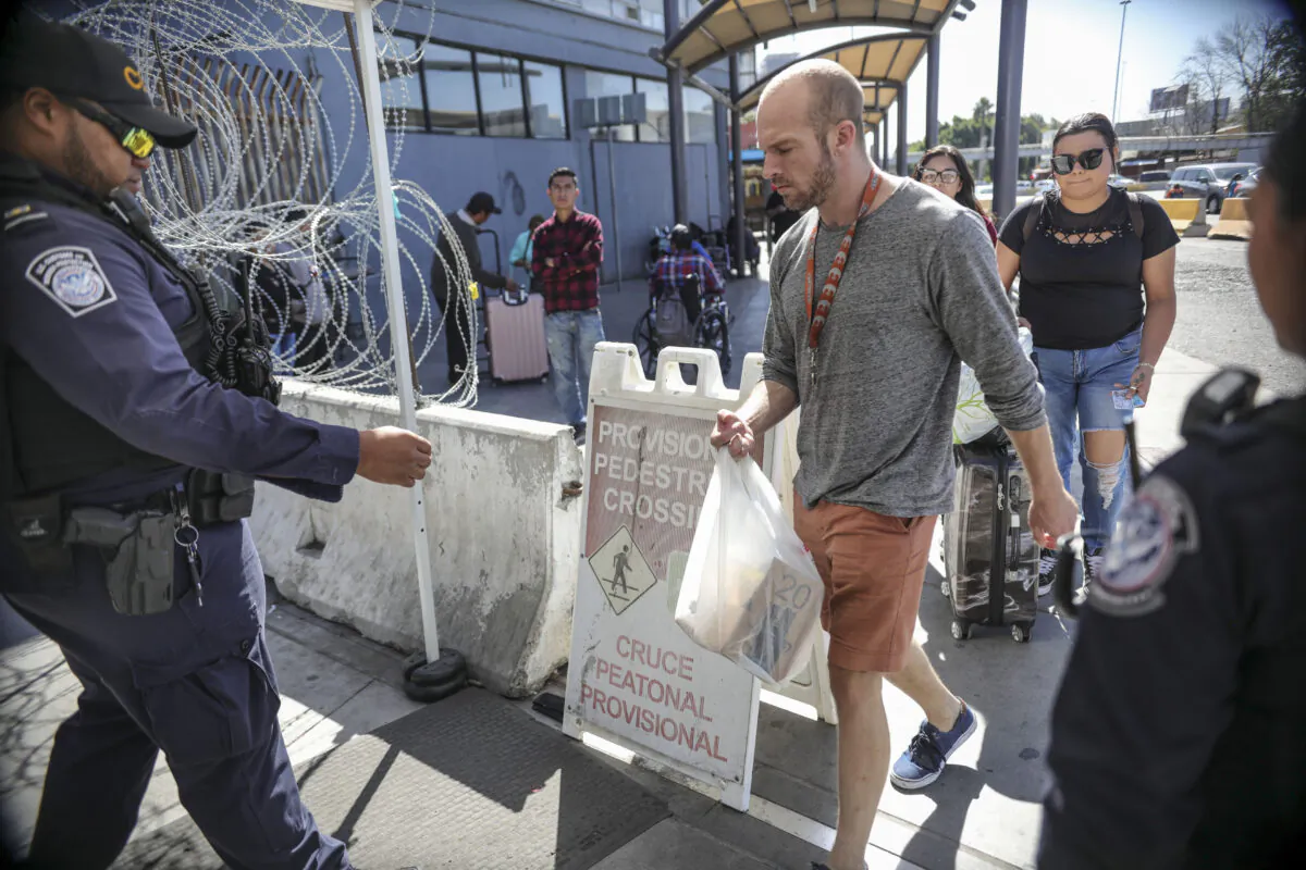An Immigration and Customs Enforcement (ICE) agent check pedestrians' documentation at the San Ysidro Port of Entry on October 2, 2019 in San Ysidro, California. - Fentanyl, a powerful painkiller approved by the US Food and Drug Administration for a range of conditions, has been central to the American opioid crisis which began in the late 1990s. China was the first country to manufacture illegal fentanyl for the US market, but the problem surged when trafficking through Mexico began around 2005, according to Donovan. (SANDY HUFFAKER/AFP via Getty Images)