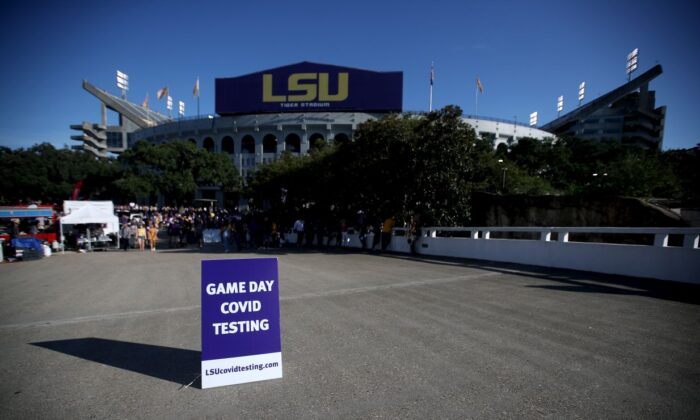 A COVID-19 testing sign is seen in front of Tiger Stadium before the game between Central Michigan and LSU on September 18, 2021 in Baton Rouge, Louisiana. Fans entering the stadium will be require to provide either proof of vaccination or a recent negative COVID-19 test to enter Tiger Stadium. (Sean Gardner/Getty Images)