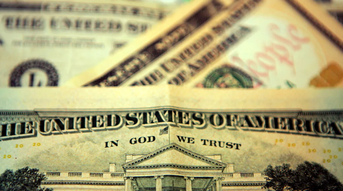 In this photo illustration the phrase "In God We Trust" can be seen on an American 10-dollar bill. (Hugh Pinney/Getty Images)