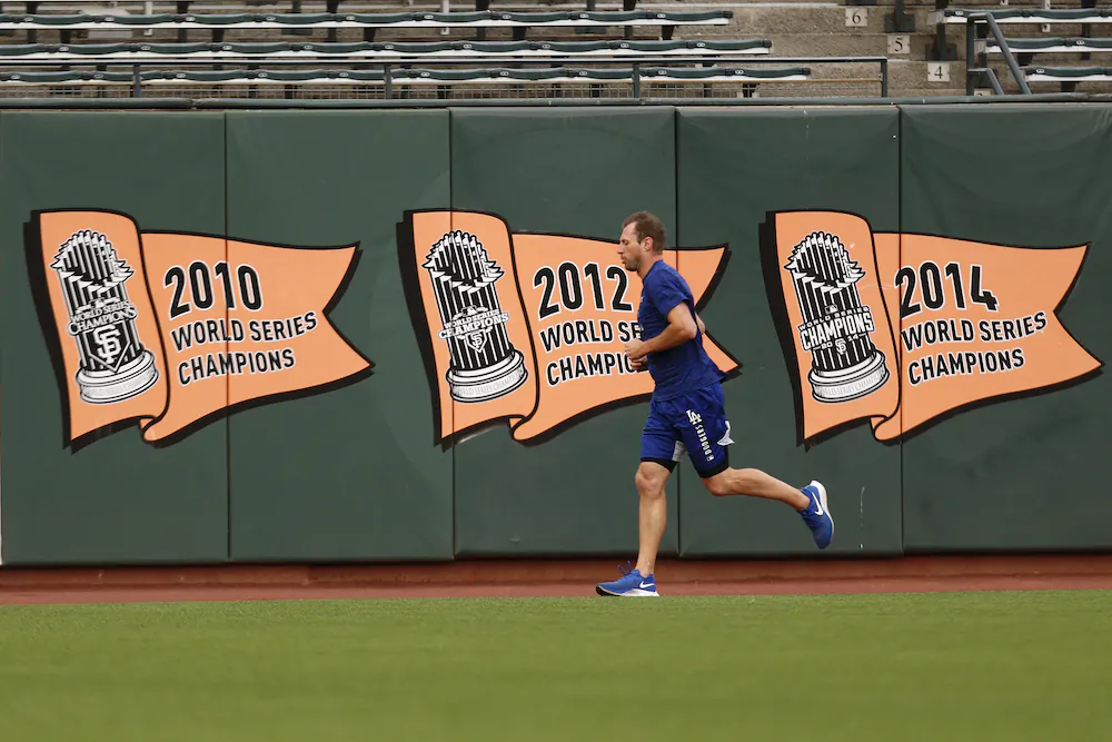 Los Angeles Dodgers' Max Scherzer runs in the outfield during a workout on Oct. 7, 2021, in San Francisco for the baseball team's National League Division Series against the San Francisco Giants, which starts Friday. (AP Photo/Jed Jacobsohn)