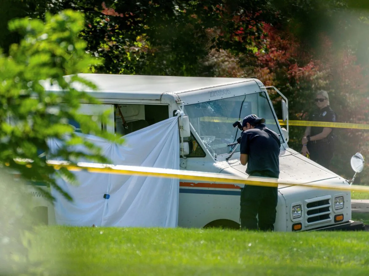 Police investigate the scene of a fatal shooting of a postal worker in Collier Township, Pa., on Oct. 7, 2021. (Andrew Rush/Pittsburgh Post-Gazette/AP Photo)