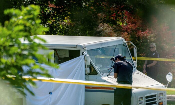 Police investigate the scene of a fatal shooting of a postal worker in Collier Township, Pa., on Oct. 7, 2021. (Andrew Rush/Pittsburgh Post-Gazette/AP Photo)
