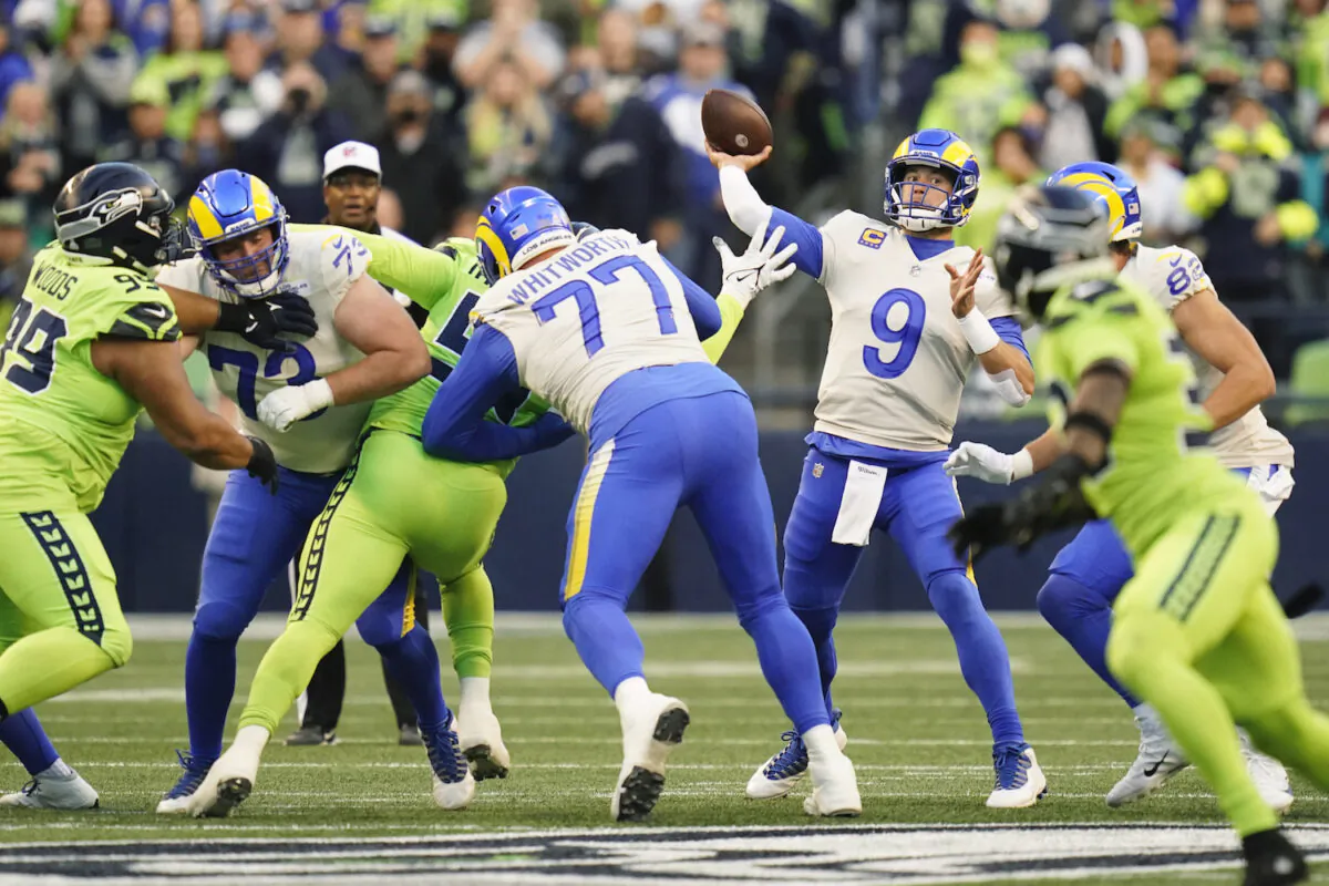 Los Angeles Rams quarterback Matthew Stafford (9) passes against the Seattle Seahawks during the first half of an NFL football game in Seattle on Oct. 7, 2021. (AP Photo/Elaine Thompson)