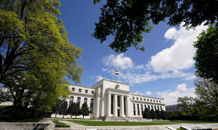 The Federal Reserve building is set against a blue sky in Wash., on May 1, 2020. (Kevin Lamarque/Reuters)