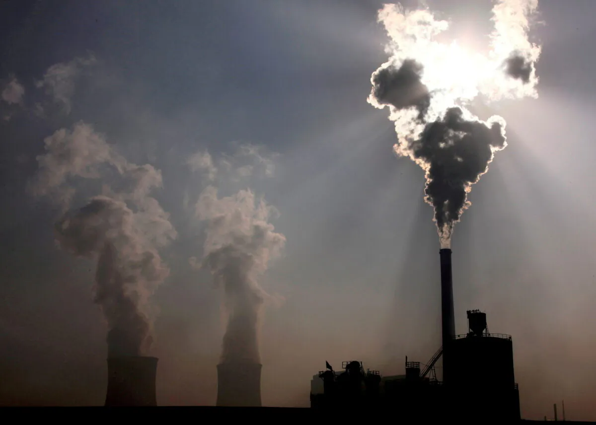 A coal-burning power plant behind a factory in the city of Baotou, China's Inner Mongolia Autonomous Region, on Oct. 31, 2010. (David Gray/Reuters)