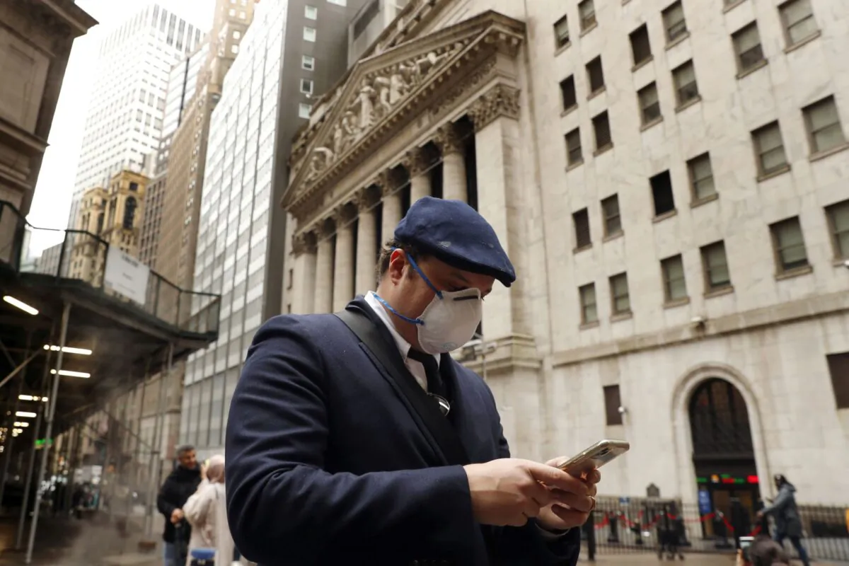 A man walks past the New York Stock Exchange on the corner of Wall and Broad streets in New York City, N.Y., on March 13, 2020. (Lucas Jackson/Reuters)