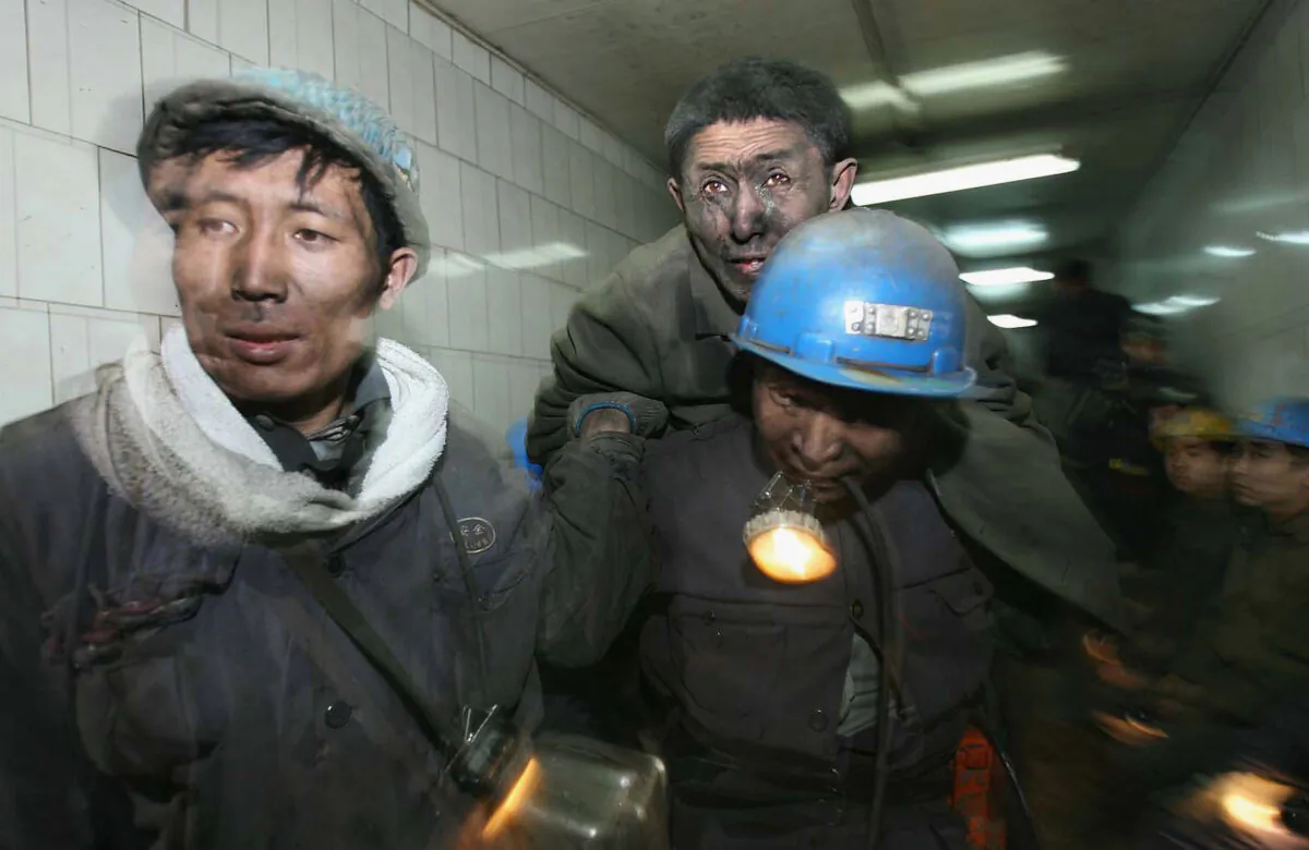 Rescuers carry a miner out after he was trapped, following a blast accident that occurred at Dongfeng Coal Mine in the suburb of Qitaihe city of Heilongjiang Province, China, on Nov. 28, 2005. (China Photos/Getty Images)