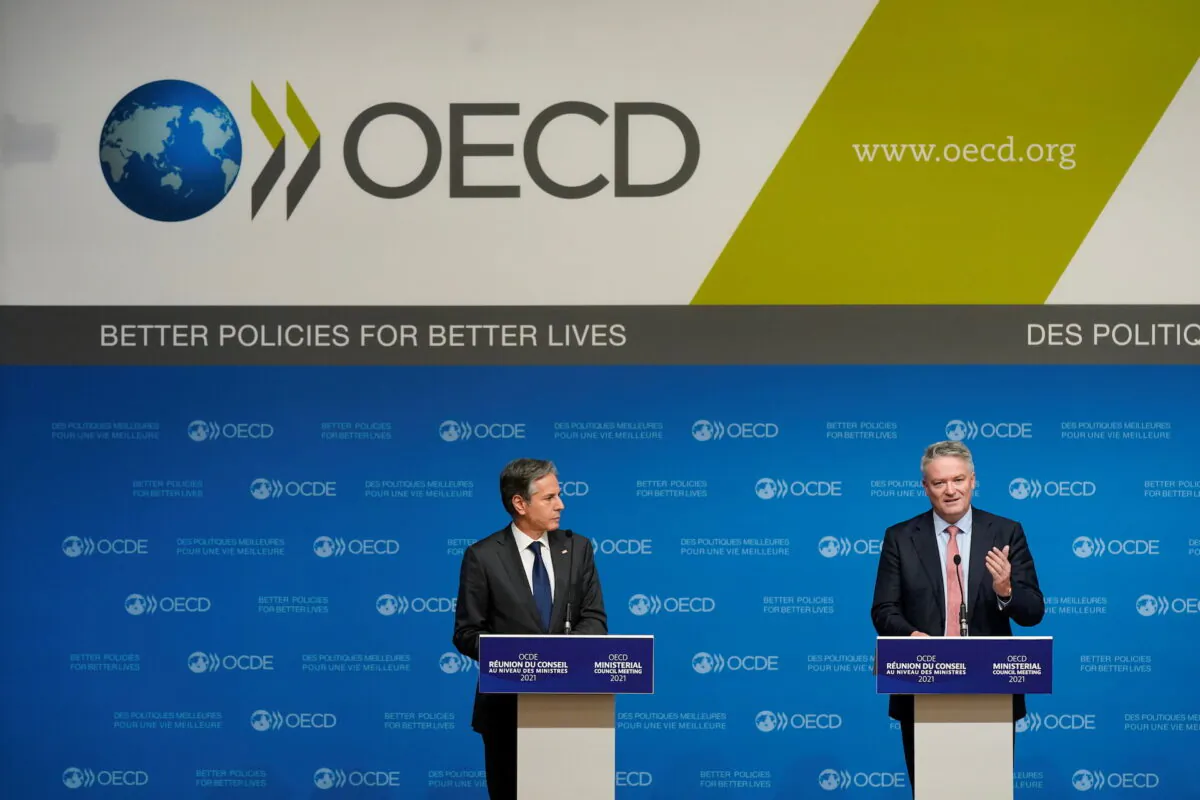 U.S. Secretary of State Antony Blinken listens as Mathias Cormann, Secretary-General of the Organization for Economic Cooperation and Development, speaks during a press briefing at the OECD's Ministerial Council Meeting, in Paris, France October 6, 2021.  (Patrick Semansky/Pool via Reuters)
