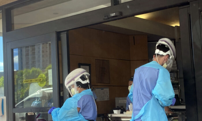 Hospital workers process COVID-19 tests at a hospital in Aiea, Hawaii, on Sept. 15, 2021. (Caleb Jones/AP Photo)