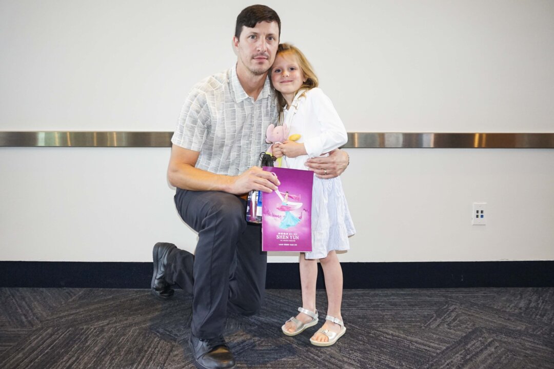 Matt Argo and daughter, Silvia, enjoy Shen Yun Performing Arts at the Kentucky Center, Whitney Hall, in Louisville, Ky., on Oct. 9, 2021. (Nancy Ma/The Epoch Times)