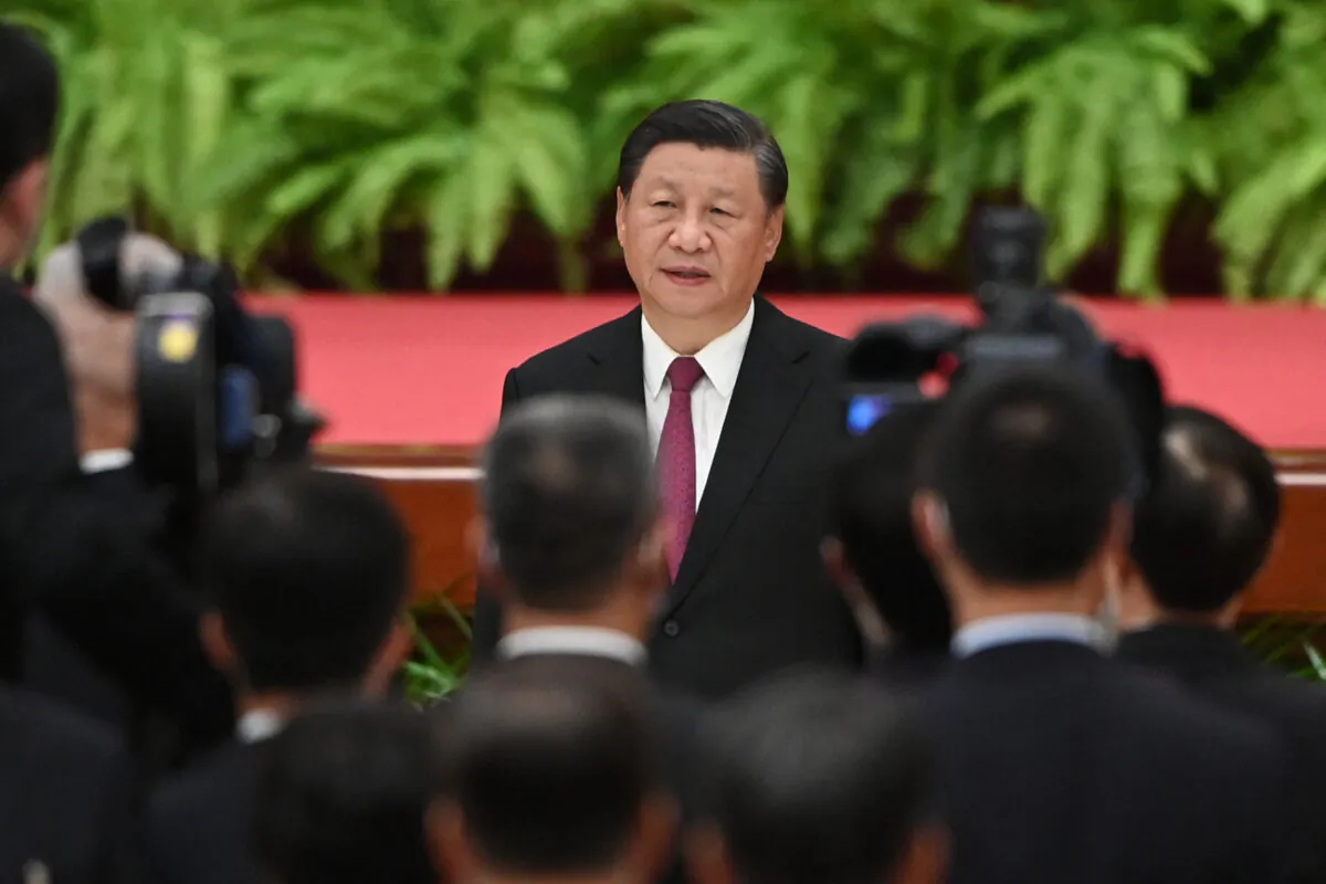 Chinese leader Xi Jinping sings the national anthem during a reception at the Great Hall of the People on the eve of the 72nd anniversary of the Chinese Communist Party's takeover of China in Beijing on Sept. 30, 2021. (Greg Baker/AFP via Getty Images)