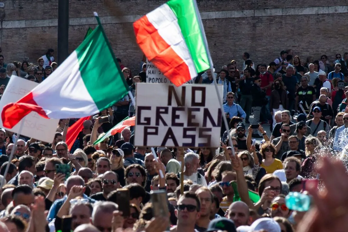 People wave national flags during a protest against the mandatory "green pass" in Rome, Italy on Oct.  9, 2021.  (TIZIANA FABI/AFP via Getty Images)