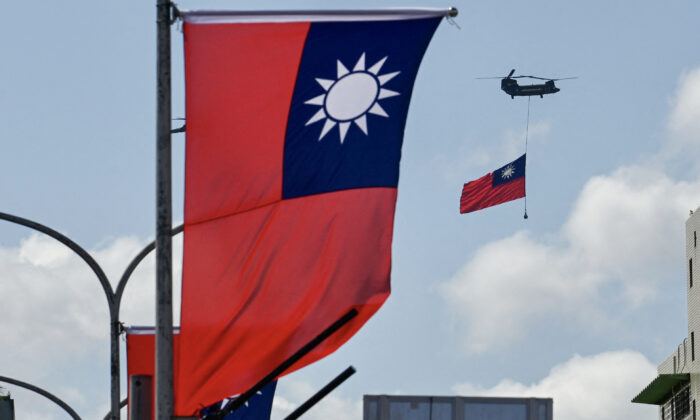 A CH-47 Chinook helicopter carries a Taiwan flag during national day celebrations in Taipei, Taiwan, on Oct. 10, 2021. (Sam Yeh/AFP via Getty Images)