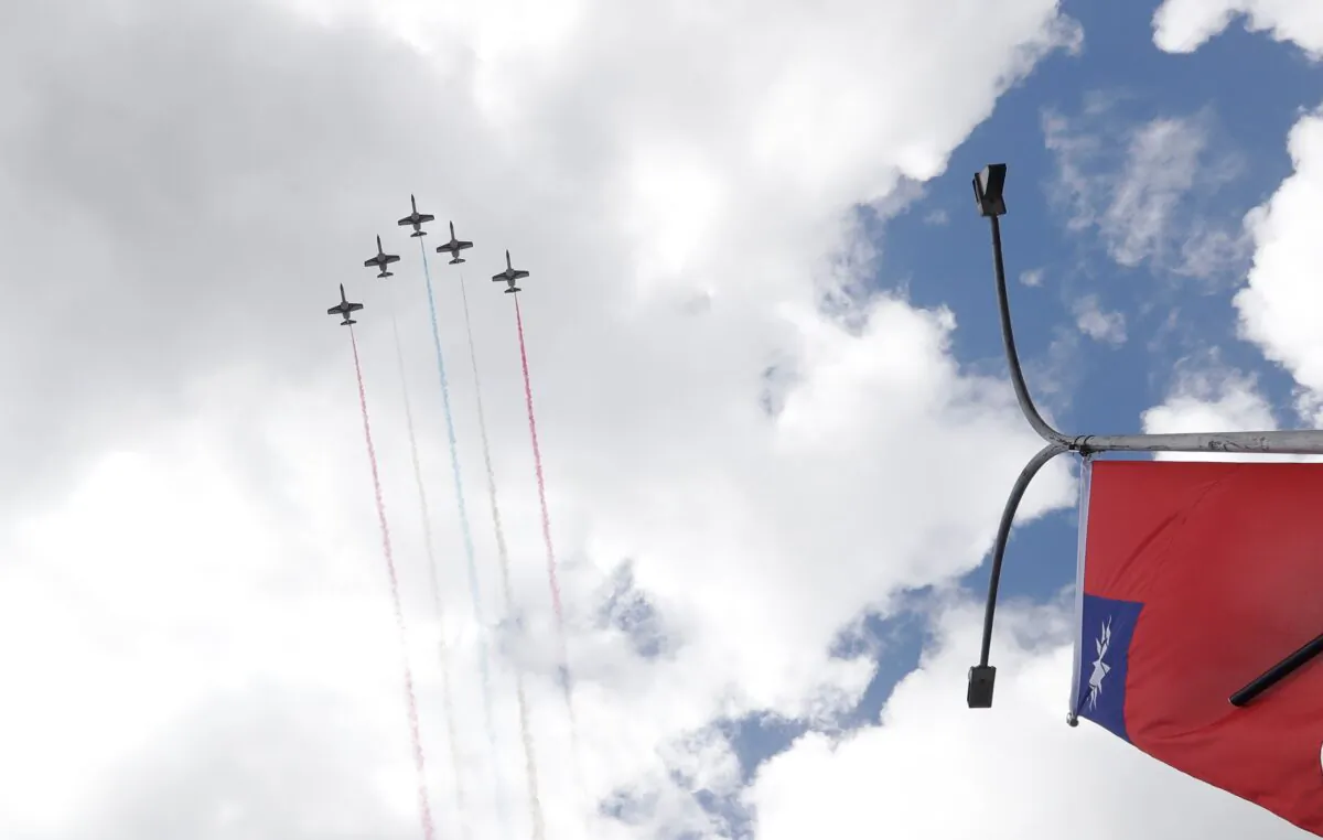 Thunder Tiger Aerobatics Team fly over President Office during National Day celebrations in Taipei, Taiwan on Oct. 10, 2021. (Chiang Ying-ying/AP Photo)