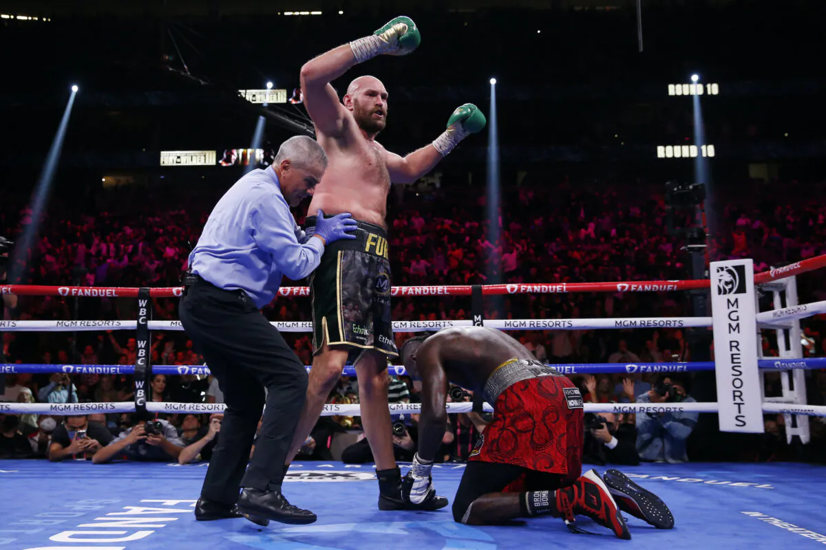 Tyson Fury, of England, knocks down Deontay Wilder in a heavyweight championship boxing match in Las Vegas, on Oct. 9, 2021. (Chase Stevens/AP Photo)