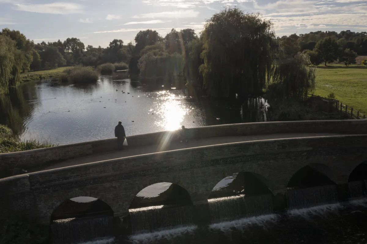 A man walks across Five Arches Bridge over the River Cray in Sidcup, United Kingdom on Oct. 06, 2021. (Dan Kitwood/Getty Images)