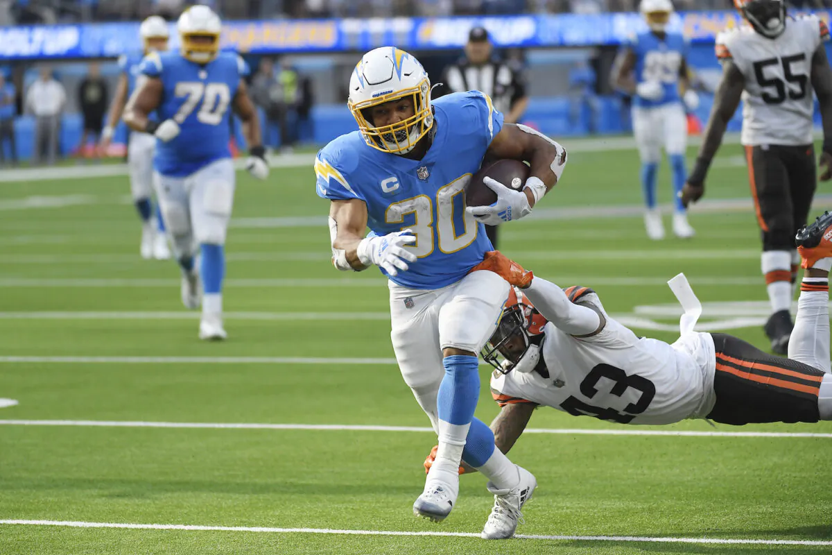 Los Angeles Chargers running back Austin Ekeler scores a touchdown past Cleveland Browns free safety John Johnson (43) during the second half of an NFL football game in Inglewood, Calif., on Oct. 10, 2021. (AP Photo/Kevork Djansezian)