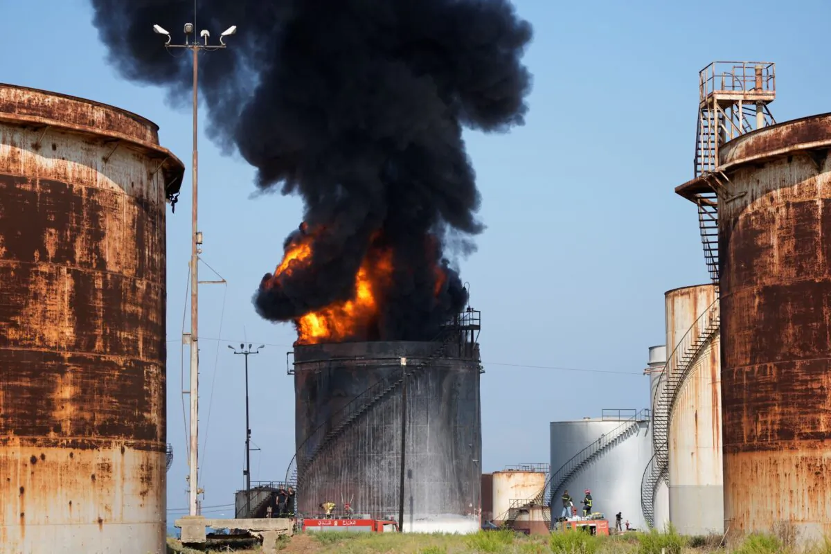 Firefighters work to extinguish a fire in an oil facility in the southern town of Zahrani, south of the port city of Sidon, Lebanon, on Oct. 11, 2021. (Hassan Ammar/AP Photo)
